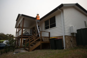 Resident inspecting home roof shingles